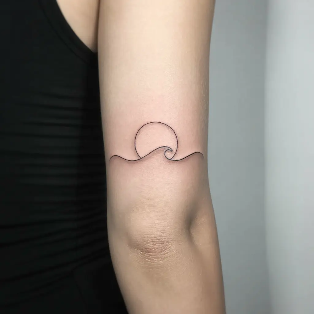 Forearm tattoo women – Sun and wave minimalist forearm tattoo with clean line art

